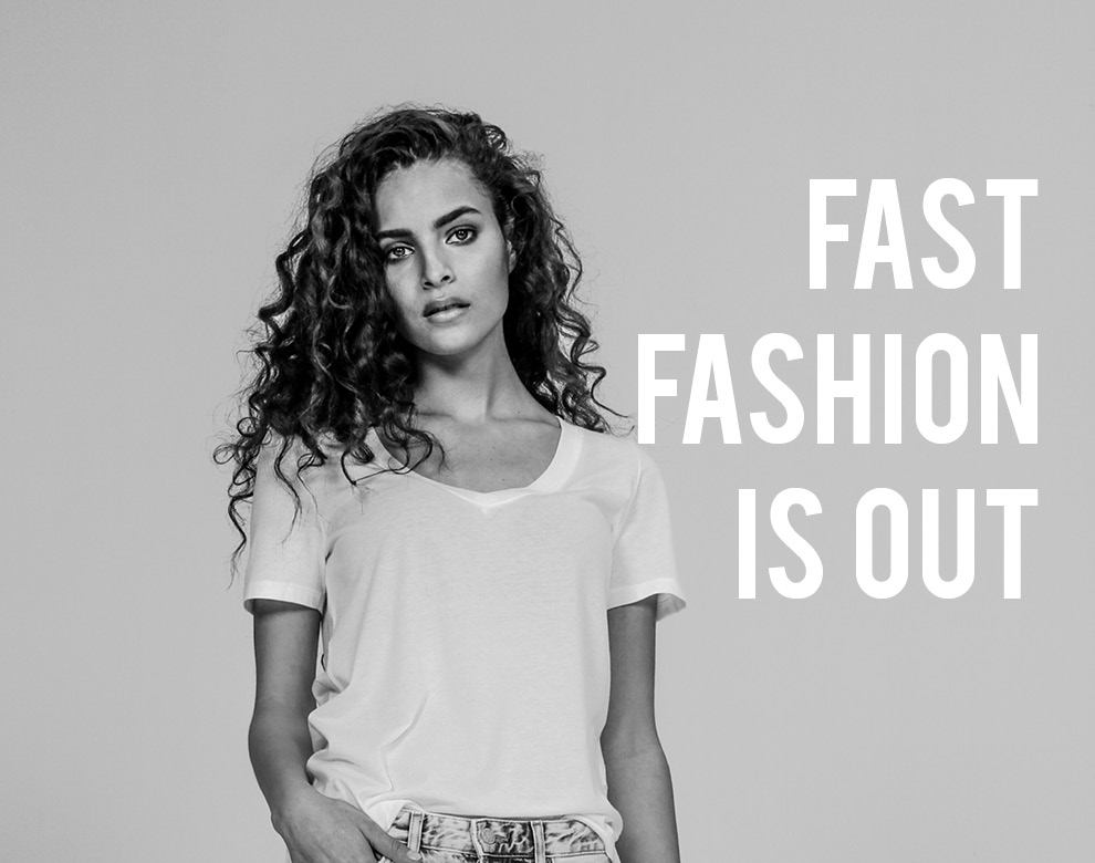 a girl in a plain white shirt, with the words ' fast fashion is out' next to her