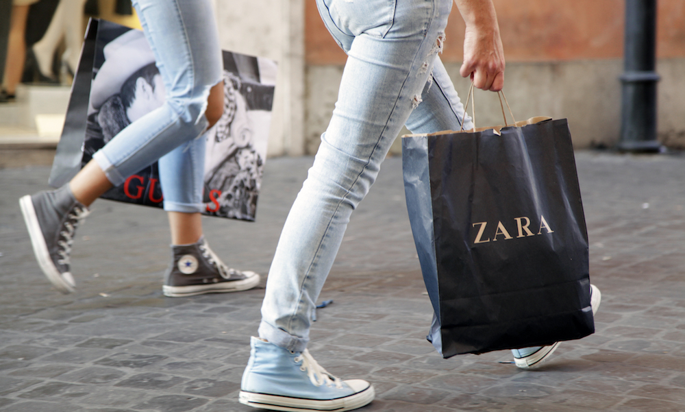 two people holding bags from Zara